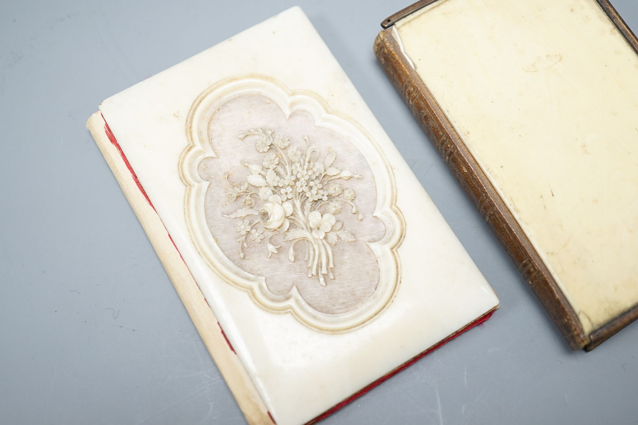 A carved ivory card case and an ivory-bound church missal, Card case 10 cms high.